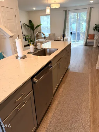 a kitchen with sink a counter space and cabinets