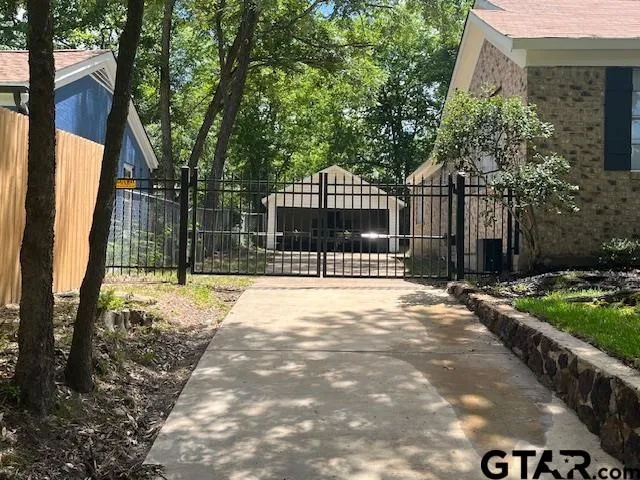 a view of house with backyard and a garden