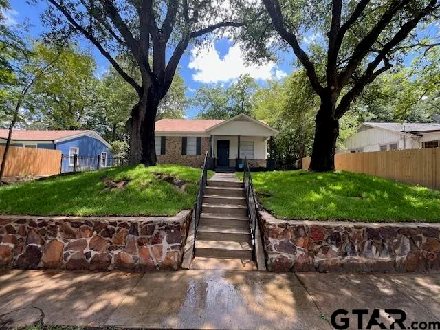 a front view of a house with a garden