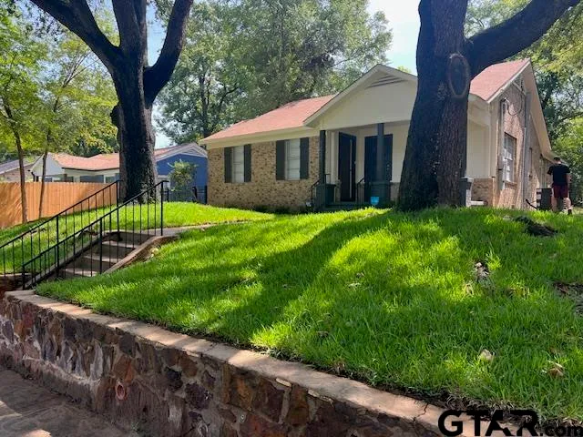 a view of house with backyard