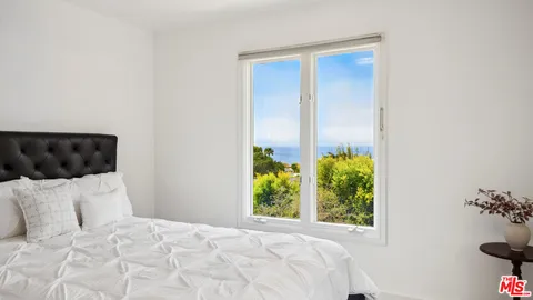 a bed room with a bed and a window