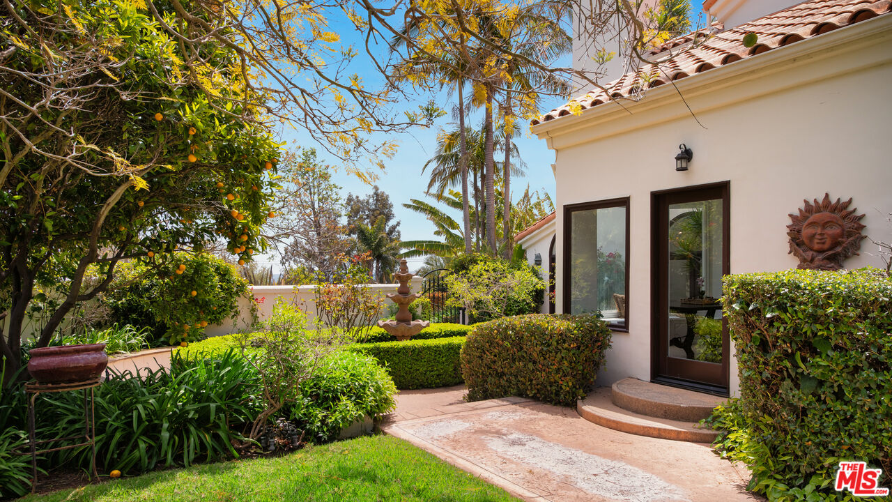 29675 Harvester Road Malibu, CA 90265 - Photo 34 of 36 a view of a patio with table and chairs potted plants and large tree