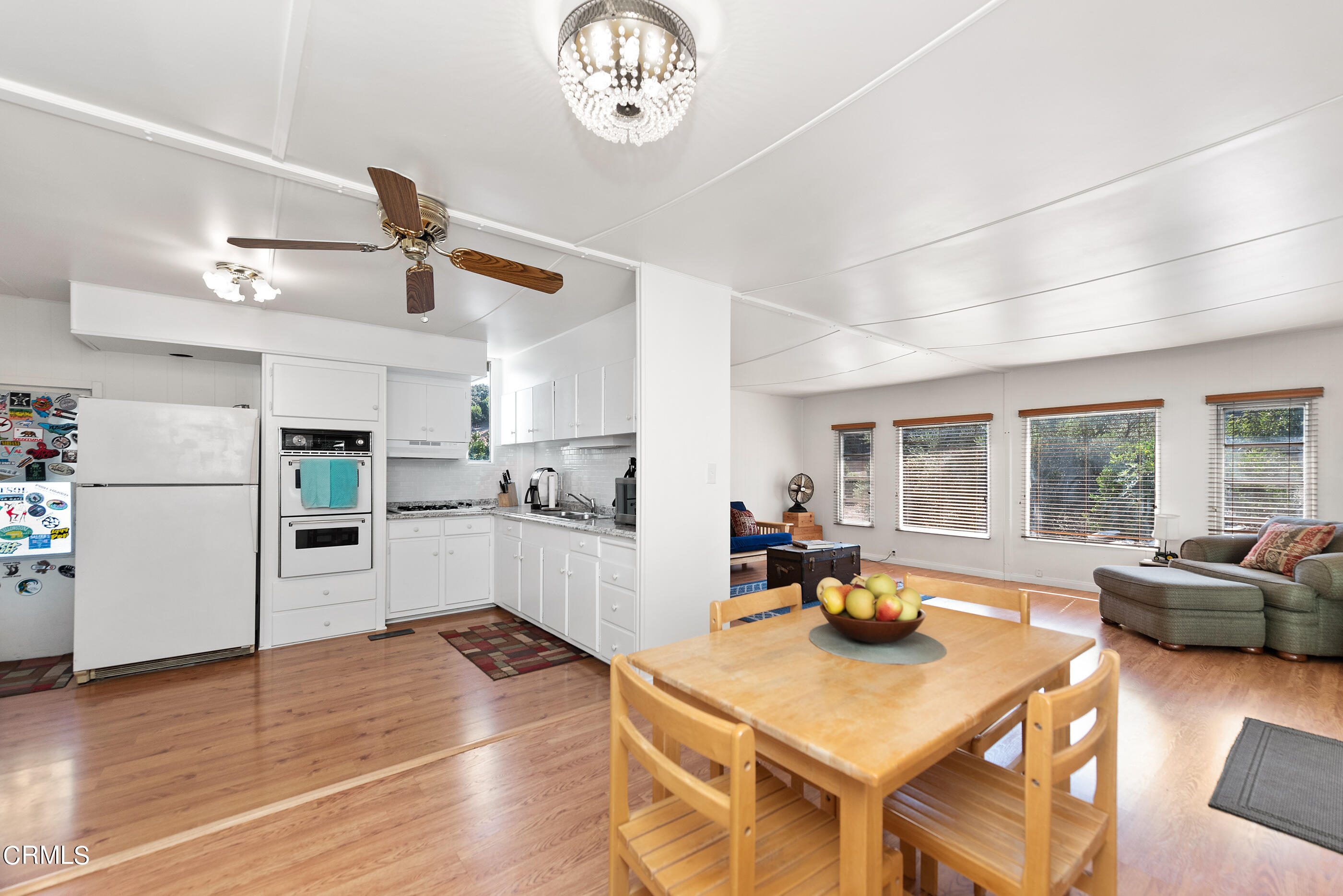 0 Chaucer Moorpark, CA 93021 - Photo 17 of 45 a living room with stainless steel appliances furniture a large window and a wooden floor