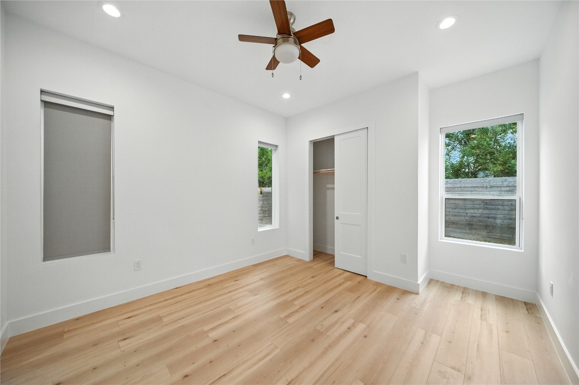 106 West Croslin Street, Unit B Austin, TX 78752 - Photo 10 of 23 an empty room with wooden floor and windows