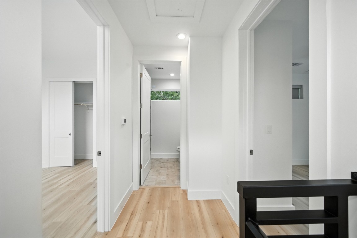 106 West Croslin Street, Unit B Austin, TX 78752 - Photo 13 of 23 a view of a hallway with wooden floor and a bathroom