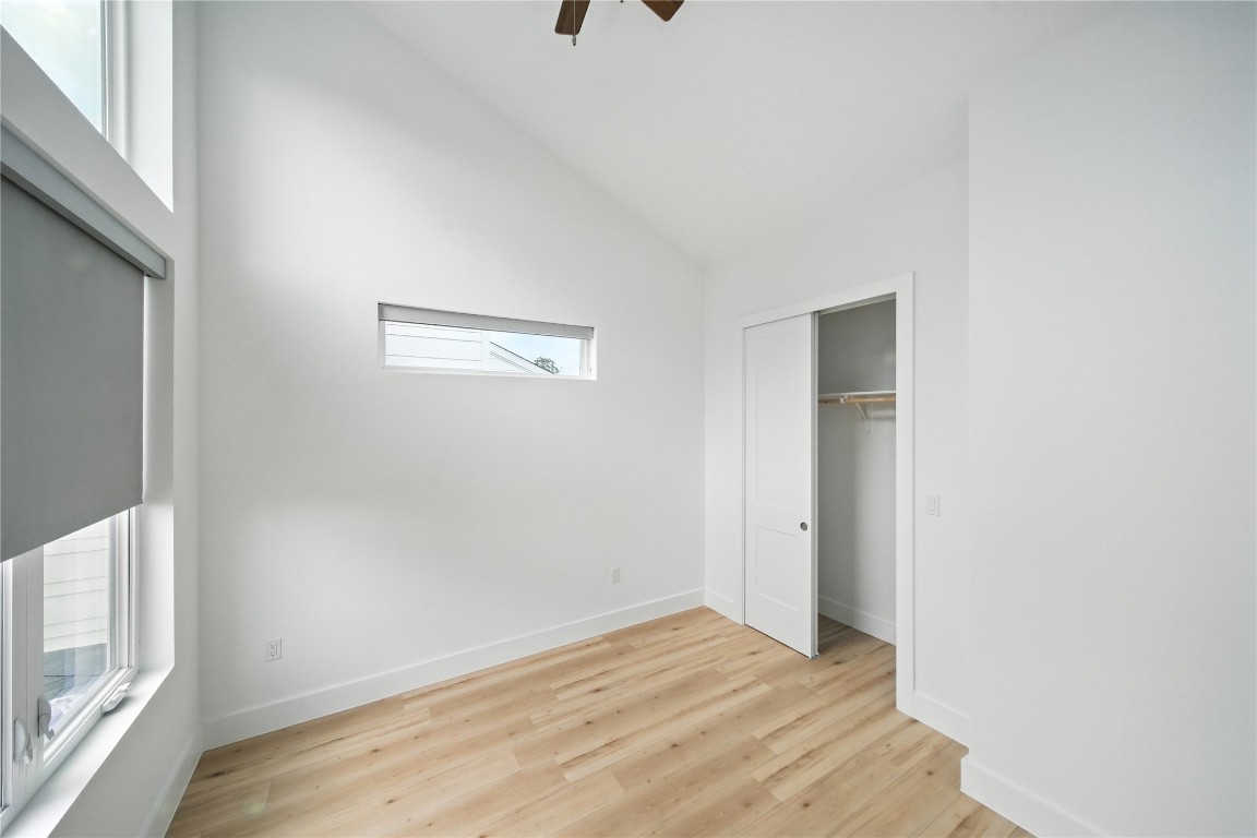 106 West Croslin Street, Unit B Austin, TX 78752 - Photo 14 of 23 a view of an empty room with wooden floor and a window