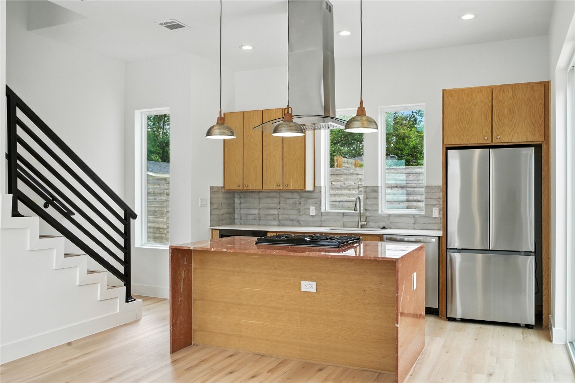 106 West Croslin Street, Unit B Austin, TX 78752 - Photo 2 of 23 a kitchen with stainless steel appliances granite countertop a refrigerator a sink and a stove