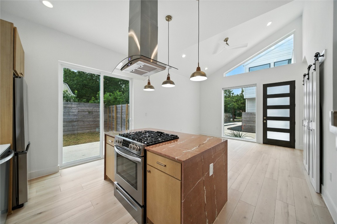 106 West Croslin Street, Unit B Austin, TX 78752 - Photo 6 of 23 a kitchen that has a stove and a wooden floor
