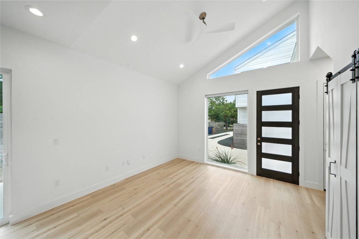 106 West Croslin Street, Unit B Austin, TX 78752 - Photo 7 of 23 wooden floor in an empty room with a window
