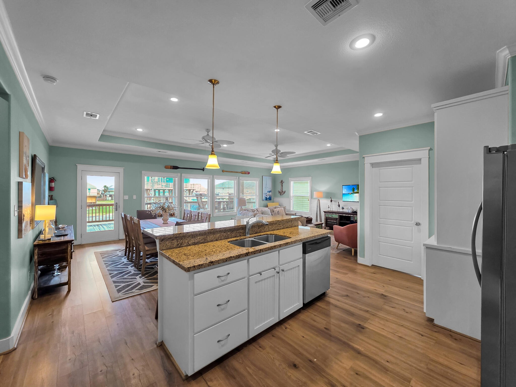 857 Wommack Crystal Beach, TX 77650 - Photo 23 of 46 a large kitchen with stainless steel appliances lots of counter space and wooden floor