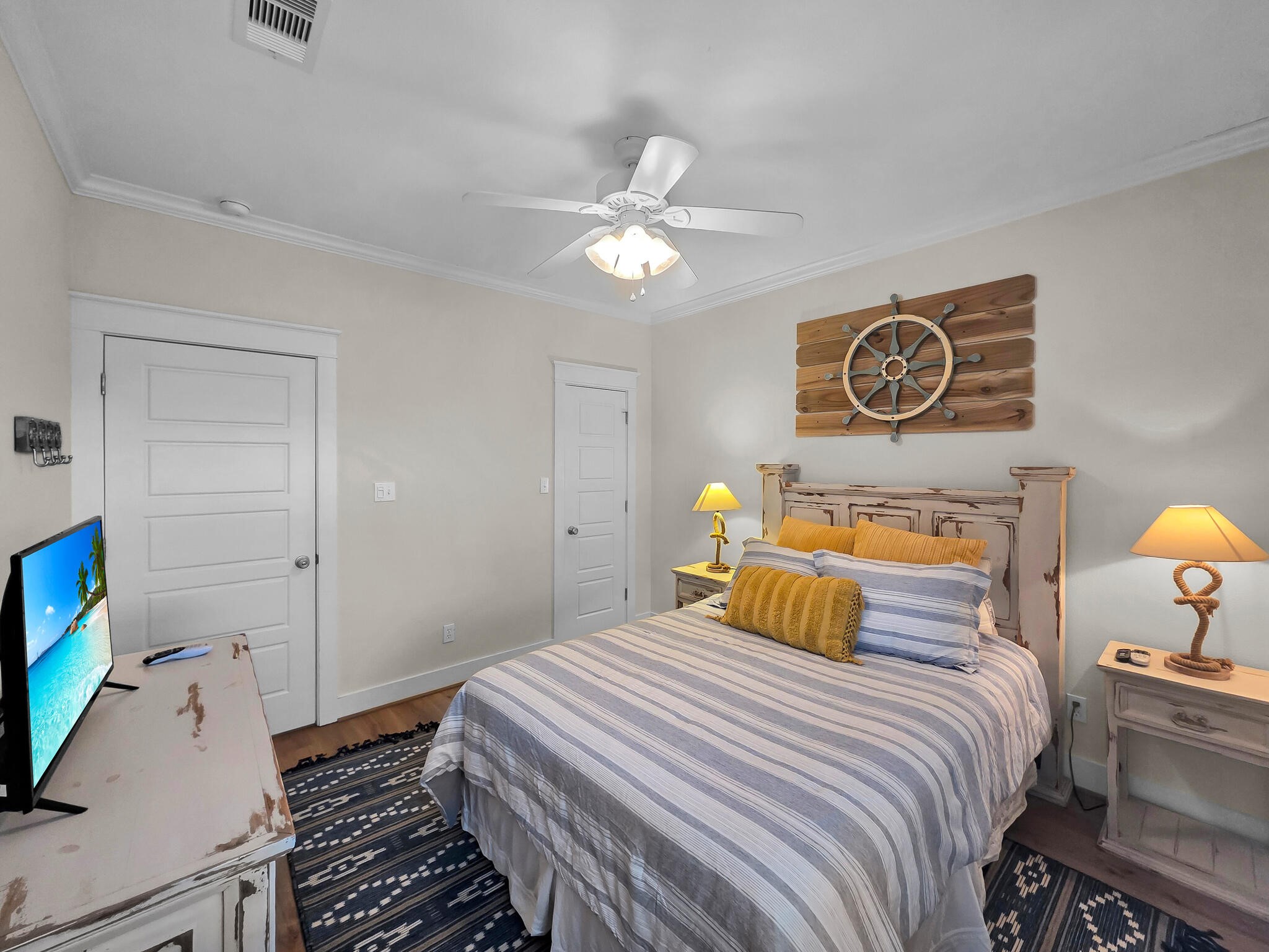 857 Wommack Crystal Beach, TX 77650 - Photo 25 of 46 a bedroom with a bed and a chandelier