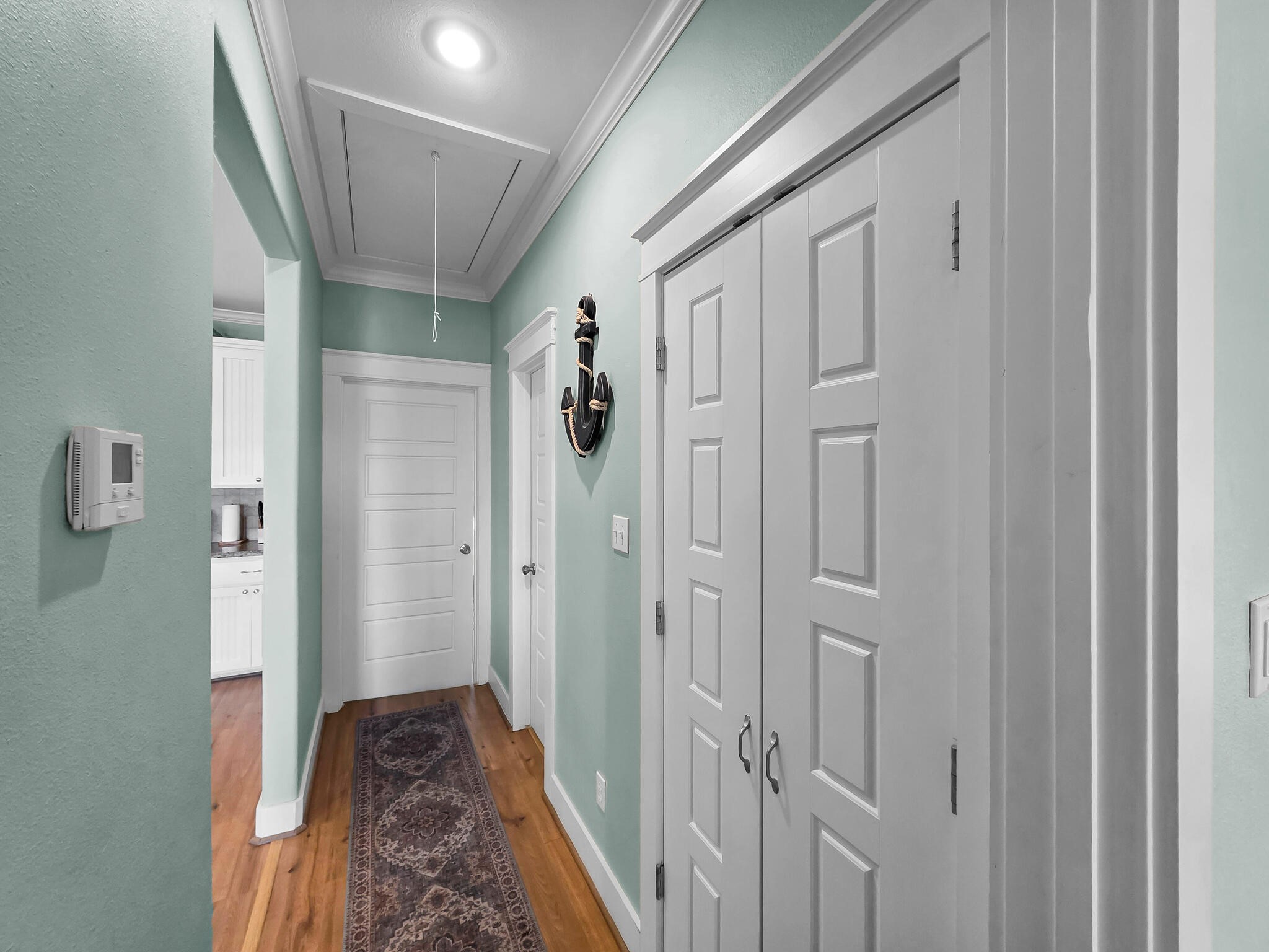 857 Wommack Crystal Beach, TX 77650 - Photo 30 of 46 a view of a hallway with wooden floor and closet area