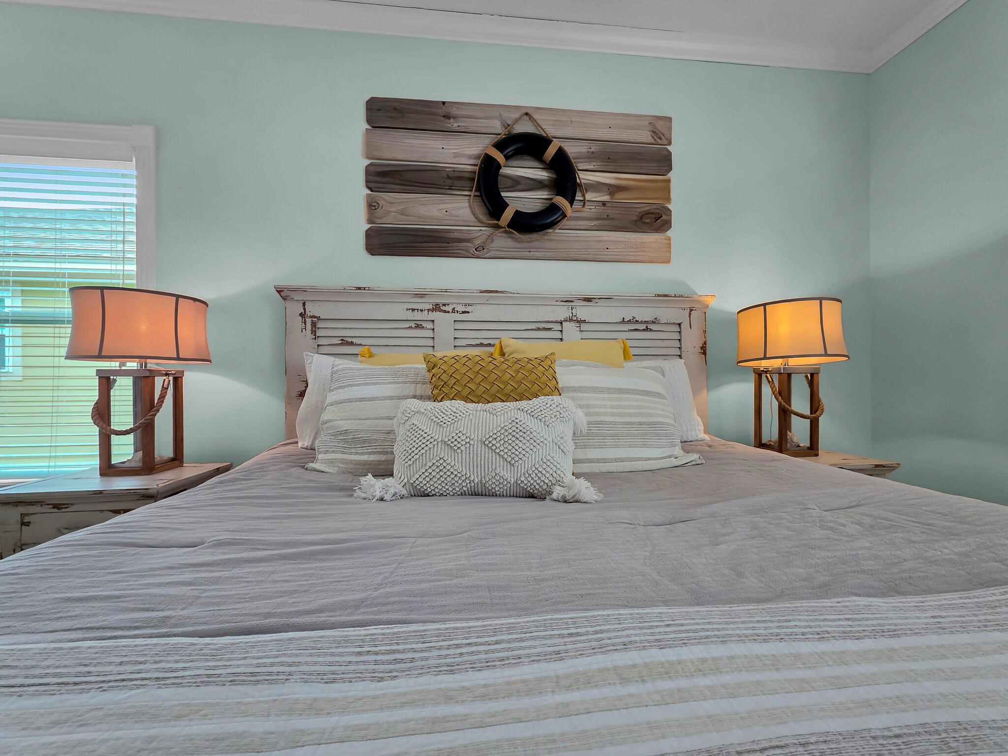 857 Wommack Crystal Beach, TX 77650 - Photo 36 of 46 a bedroom with a bed and a lamp on dresser