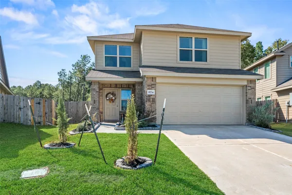a view of a chair and table in backyard of the house