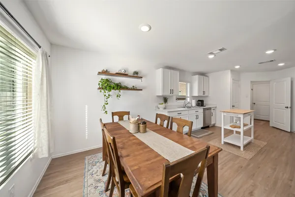 a view of a dining room with furniture and wooden floor