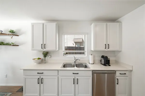 a kitchen with a sink cabinets and window