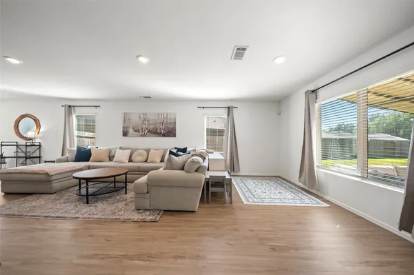 a living room with fireplace furniture and a large window
