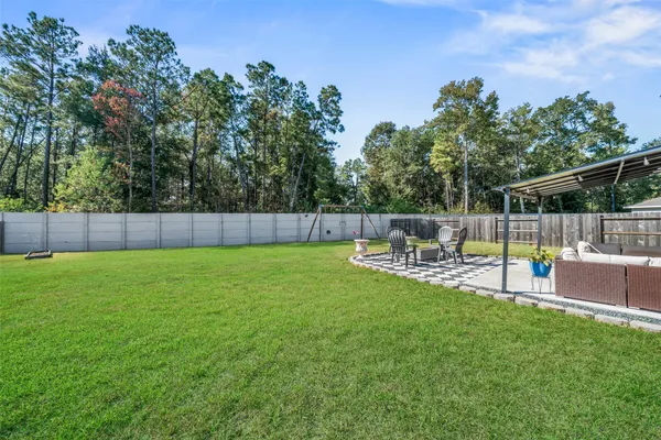 a view of yard with swimming pool and bench in the background