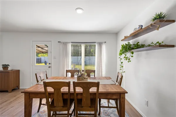 a view of a dining room with furniture and window
