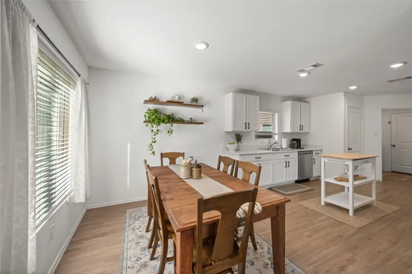 a view of kitchen with cabinets and wooden floor