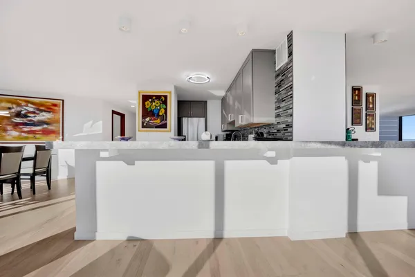 a view of kitchen with furniture and a refrigerator
