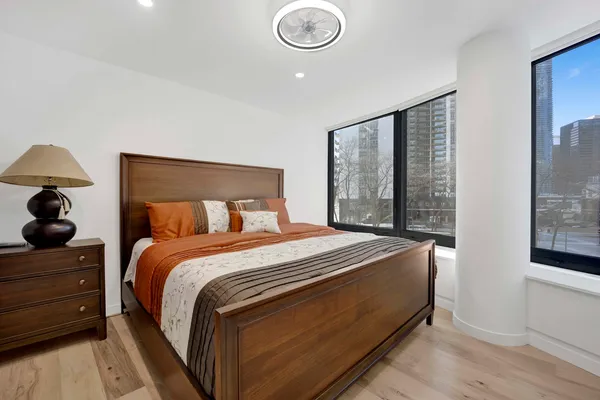 a bed sitting in a bedroom next to a window