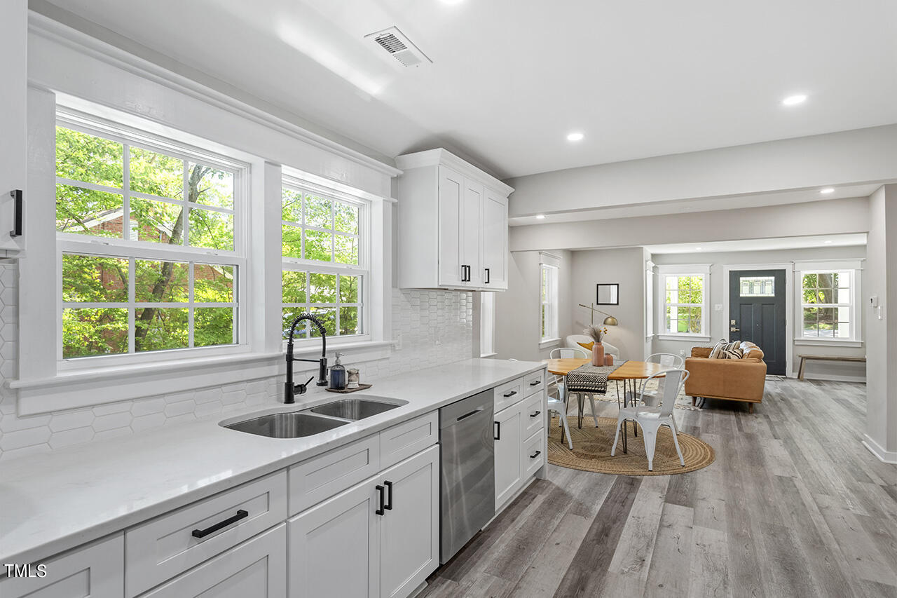 2241 Sheffield Road Raleigh, NC 27610 - Photo 14 of 33 a large kitchen with stainless steel appliances lots of counter space and windows