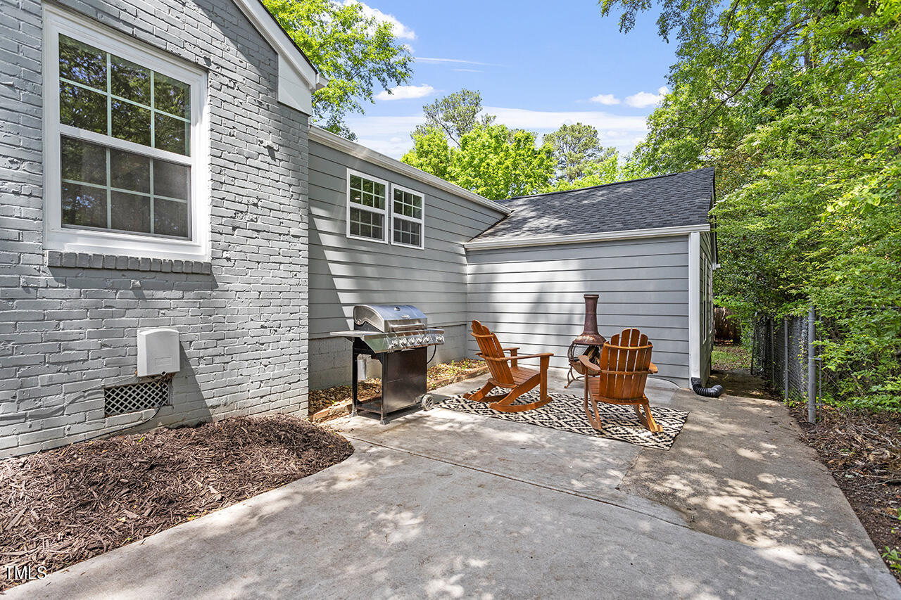 2241 Sheffield Road Raleigh, NC 27610 - Photo 28 of 33 a view of a patio with table and chairs and wooden fence
