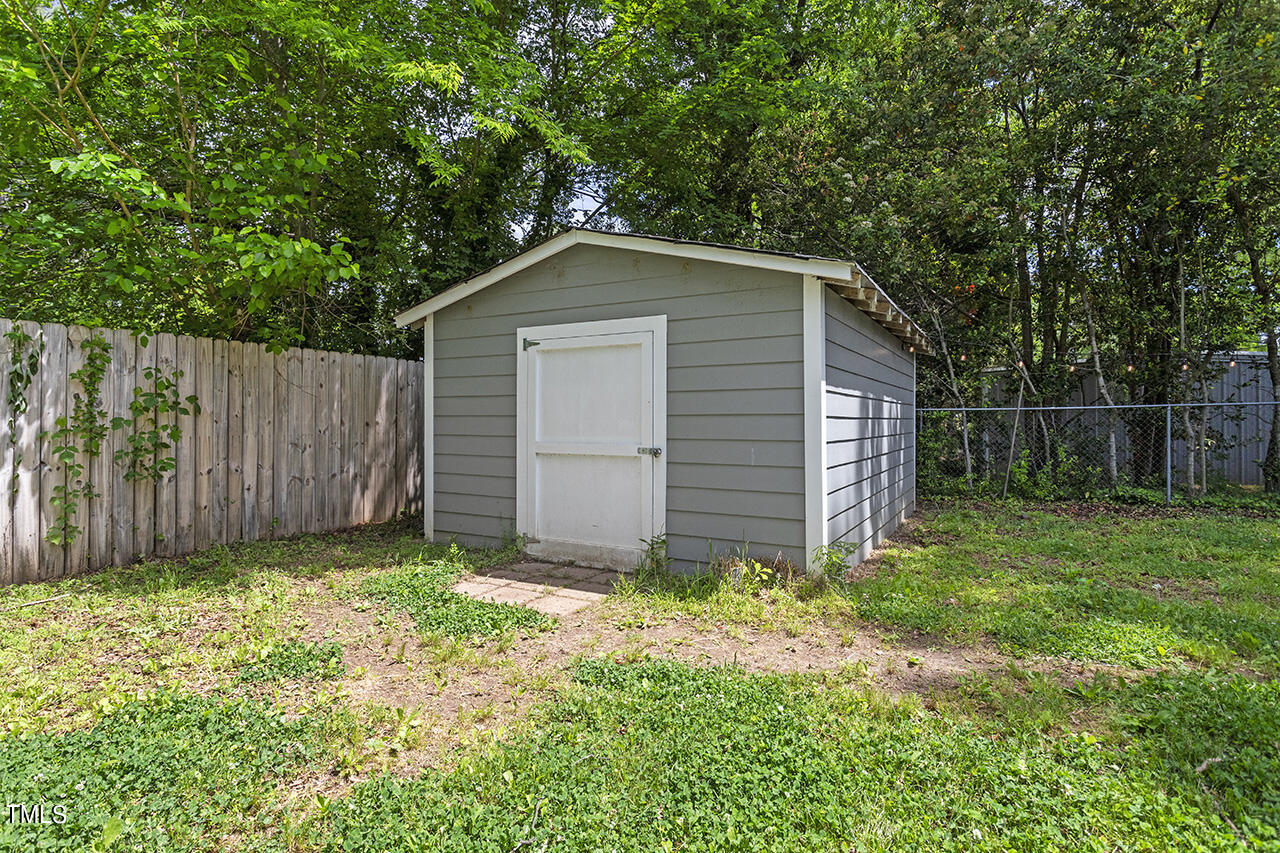 2241 Sheffield Road Raleigh, NC 27610 - Photo 29 of 33 a view of backyard with large trees and wooden fence