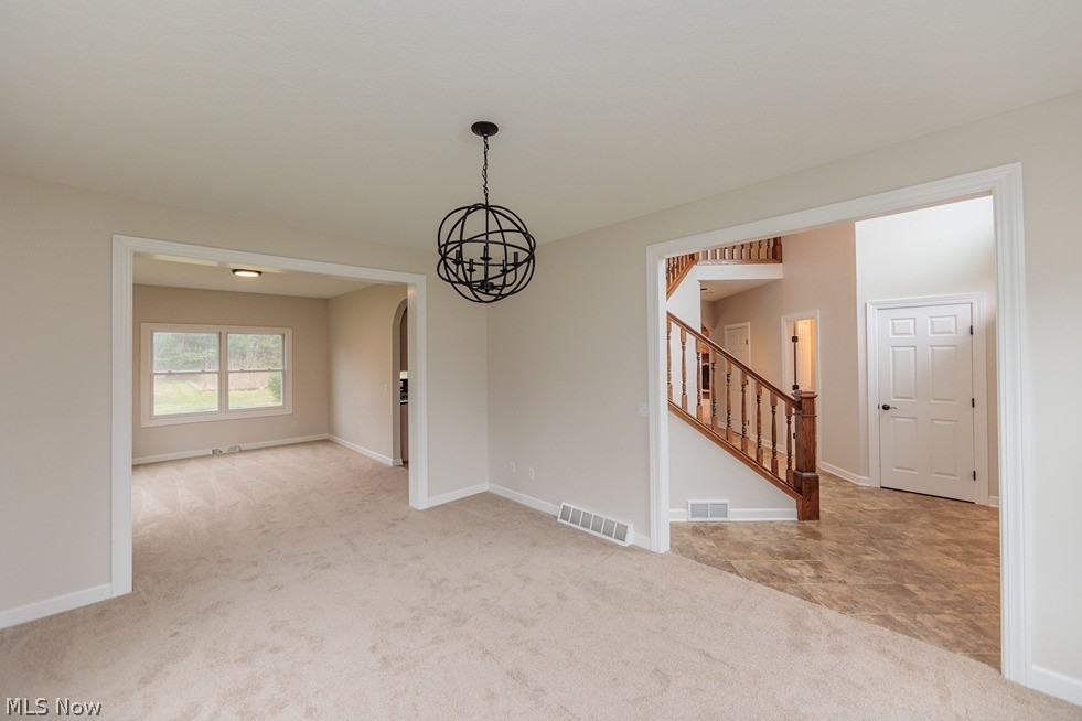 6947 Som Center Road Solon, OH 44139 - Photo 15 of 50 Spare room featuring an inviting chandelier and light colored carpet