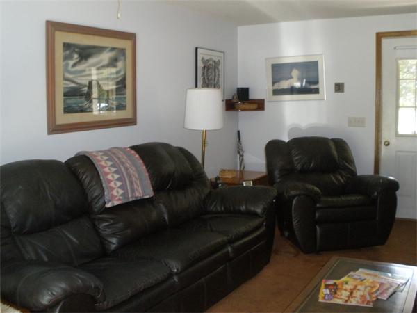 33 Woodland Road Rochester, MA 02770 - Photo 8 of 16 a living room with furniture and a lamp