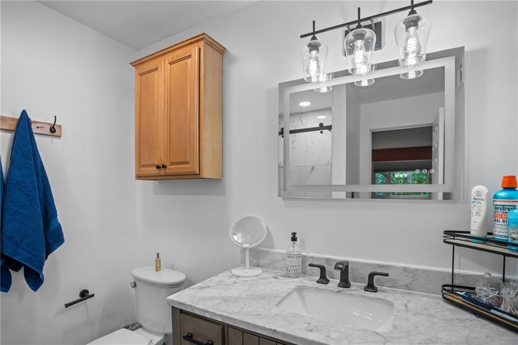1706 Kenzie Road Pittsburgh, PA 15205 - Photo 14 of 25 a bathroom with a sink a toilet and mirror