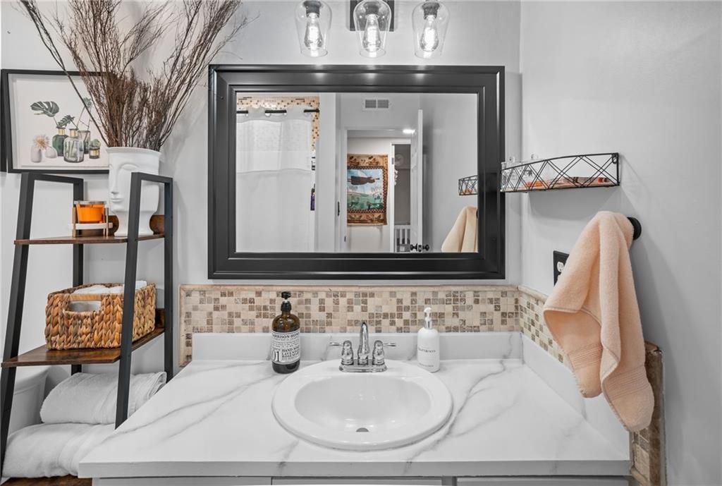 1706 Kenzie Road Pittsburgh, PA 15205 - Photo 19 of 25 a bathroom with a sink and a mirror