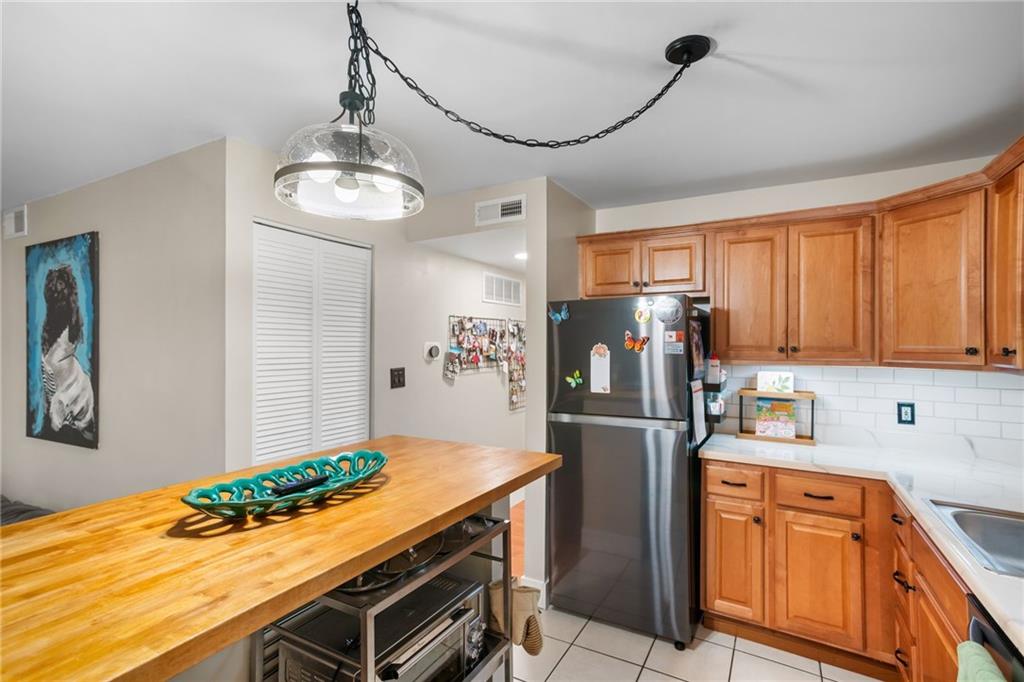 1706 Kenzie Road Pittsburgh, PA 15205 - Photo 8 of 25 a kitchen with stainless steel appliances granite countertop a refrigerator and a stove top oven