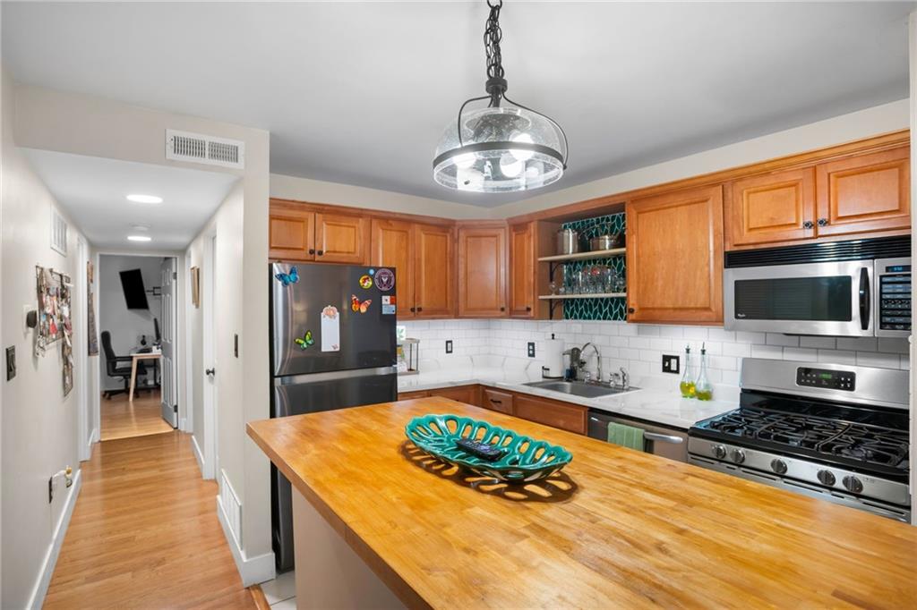 1706 Kenzie Road Pittsburgh, PA 15205 - Photo 9 of 25 a kitchen with stainless steel appliances granite countertop a stove and a view of dining hall with granite countertops