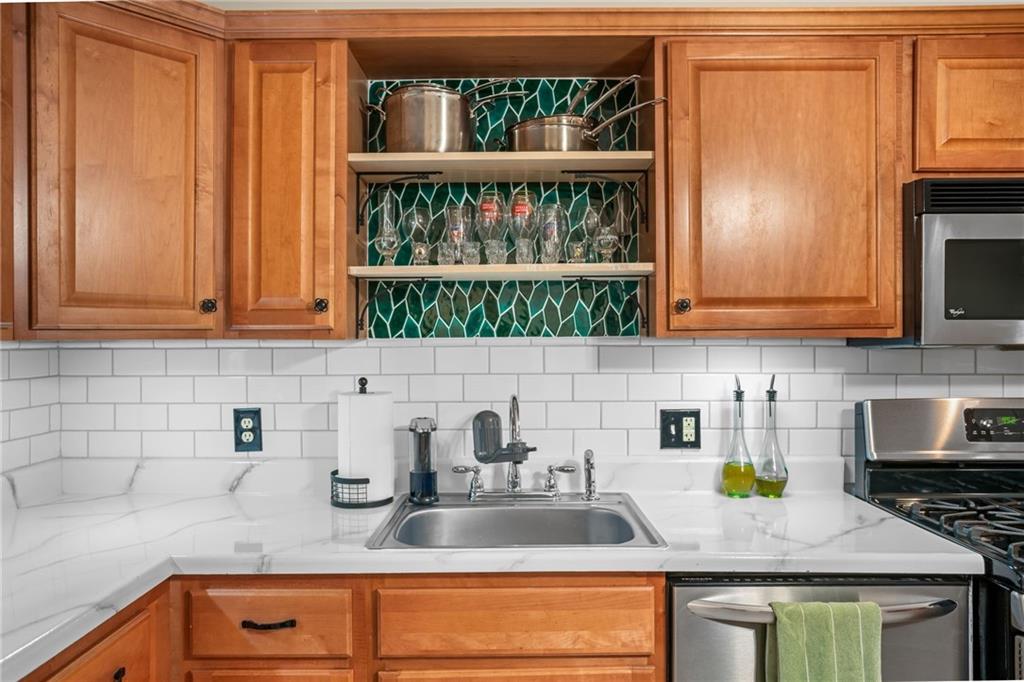1706 Kenzie Road Pittsburgh, PA 15205 - Photo 10 of 25 a kitchen with granite countertop a sink stainless steel appliances and cabinets