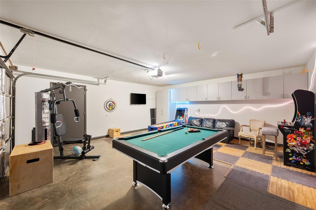 424 Windjammer Lane Azle, TX 76020 - Photo 10 of 37 Recreation room with a garage, pool table, and finished concrete flooring