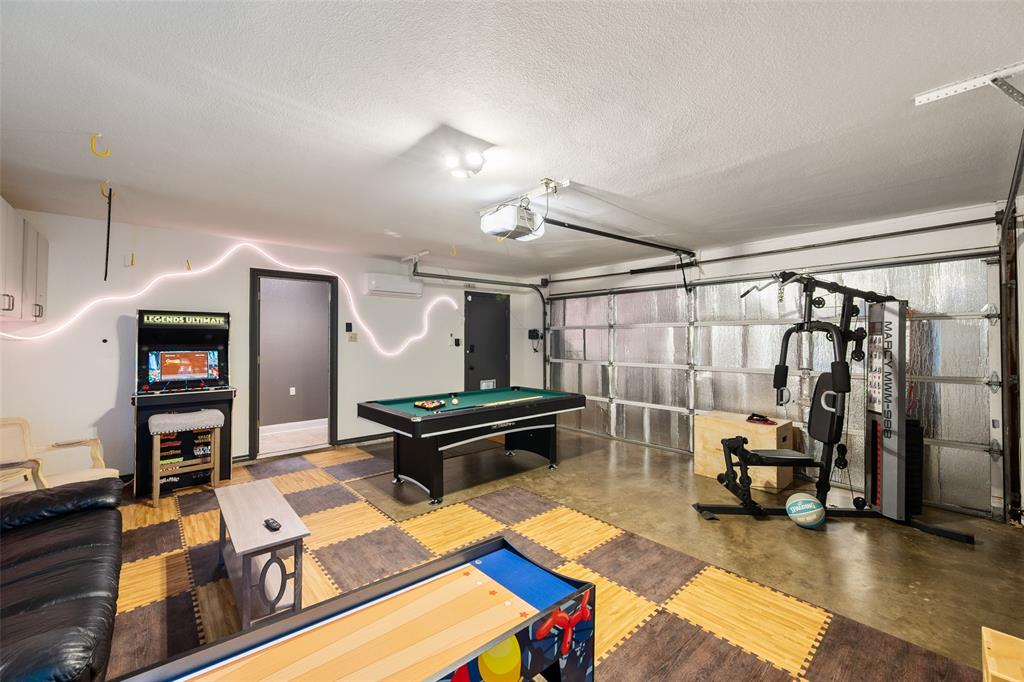 424 Windjammer Lane Azle, TX 76020 - Photo 11 of 37 Game room featuring a garage, concrete flooring, pool table, and a textured ceiling