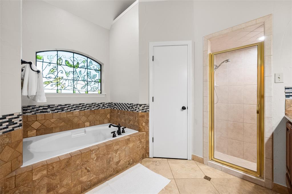 424 Windjammer Lane Azle, TX 76020 - Photo 12 of 37 Bathroom with a garden tub, a shower stall, light tile patterned floors, and vanity