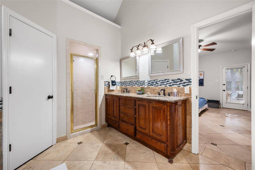 424 Windjammer Lane Azle, TX 76020 - Photo 13 of 37 Ensuite bathroom featuring a stall shower, tasteful backsplash, light tile patterned floors, and ceiling fan