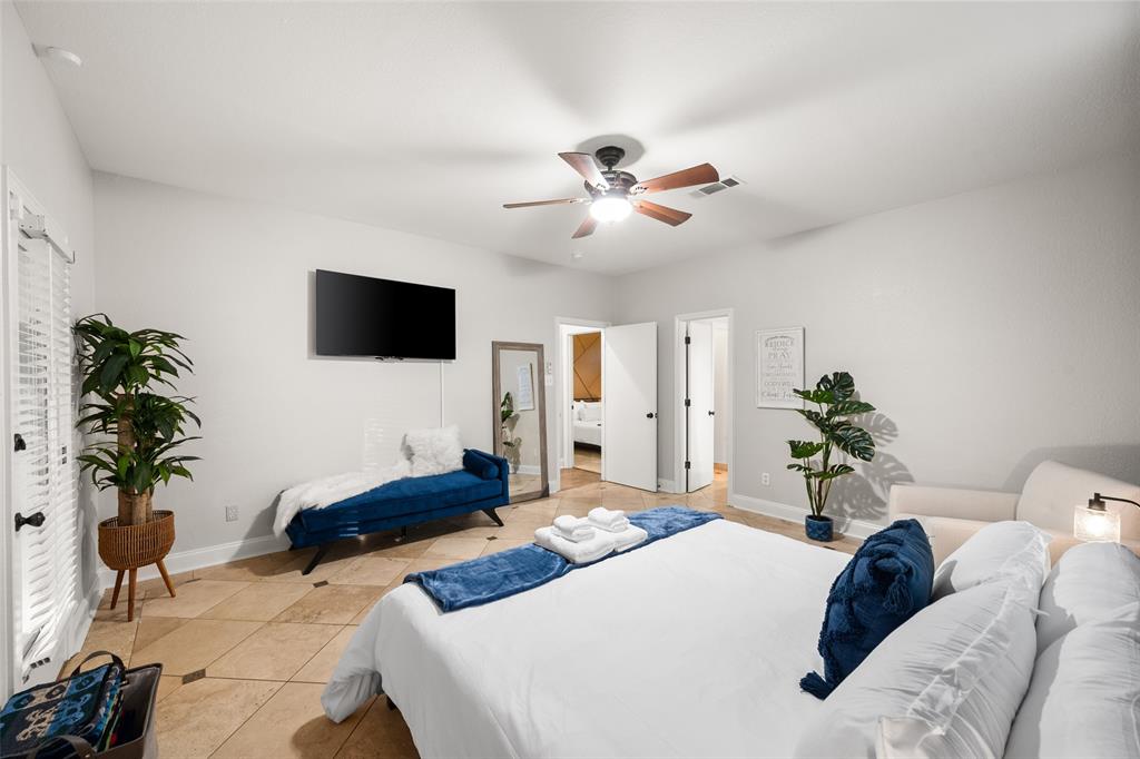 424 Windjammer Lane Azle, TX 76020 - Photo 15 of 37 Bedroom featuring tile patterned flooring, a ceiling fan, and connected bathroom