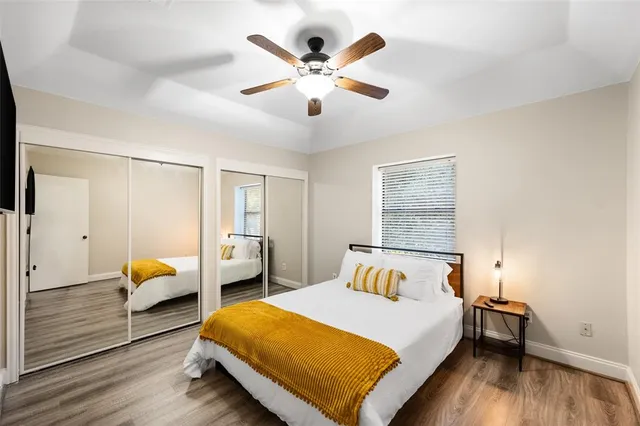 a spacious bedroom with a bed and a dresser