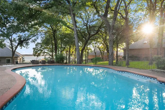 a view of pool with trees in the background