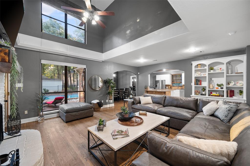 424 Windjammer Lane Azle, TX 76020 - Photo 4 of 37 Living room featuring arched walkways, wood finished floors, a ceiling fan, and a towering ceiling