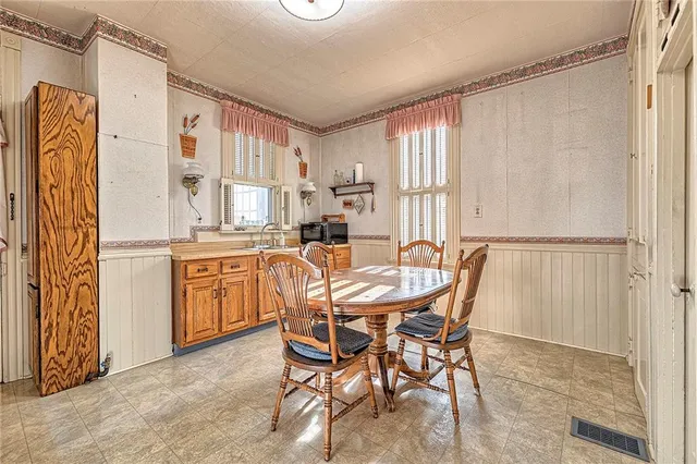 a dining room with furniture and window