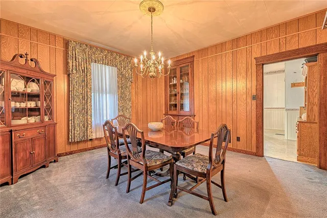 a view of a hallway with wooden floor and stairs