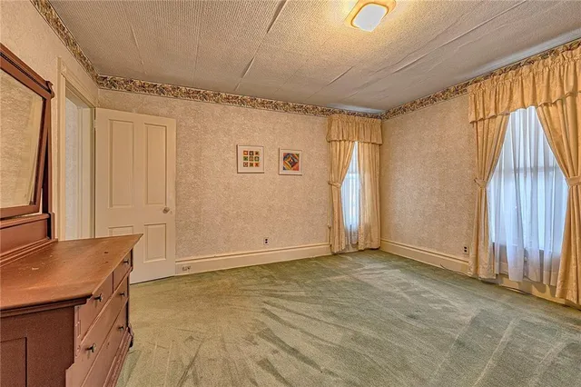 an empty room with furniture and wooden floor