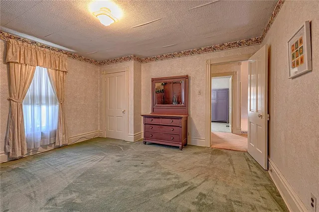 a view of a room with wooden floor and chair