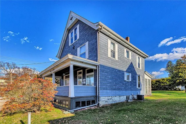 a view of house with a yard
