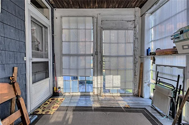 a view of an empty room and wooden floor